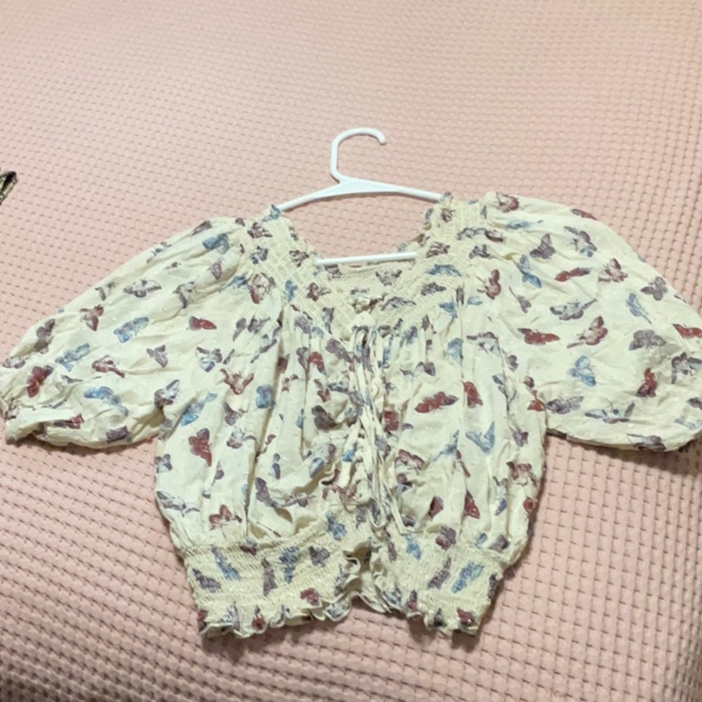 Butterfly snitched top tied it the front .